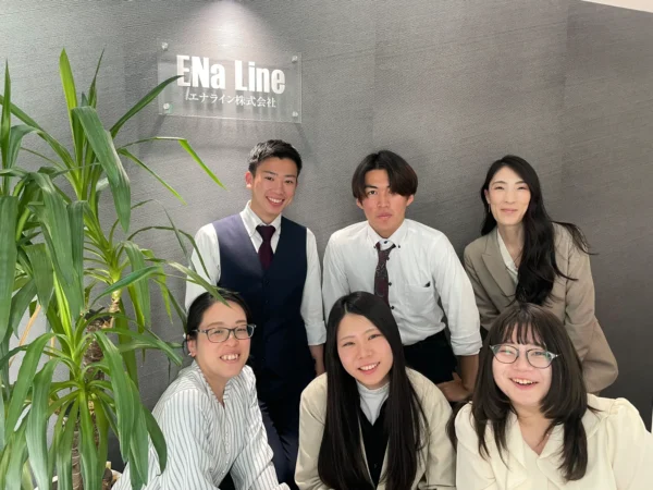 エナラインのロゴの前に並ぶエナライン株式会社の皆さま